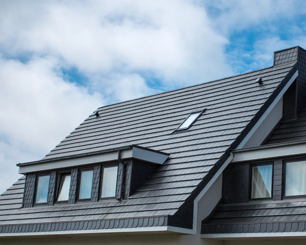 Newly installed black roof on a suburban home done by Moss Doctors home exterior experts.